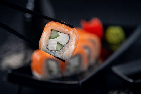 Philadelphia sushi roll to eat with chopsticks, close-up, selective focusの写真素材