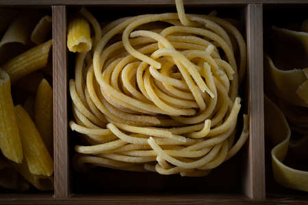 traditional Italian spaghetti pasta in a wooden box, top viewの写真素材
