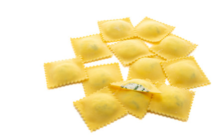 Fresh Ravioli pasta with ricotta cheese topping golden color isolated on white background, top viewの写真素材