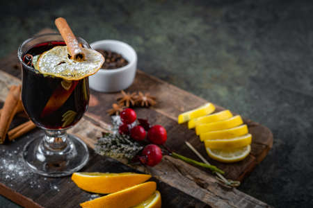 Christmas red wine mulled wine in glasses with spices and cinnamon on a wooden Board. Winter hot drinkの写真素材