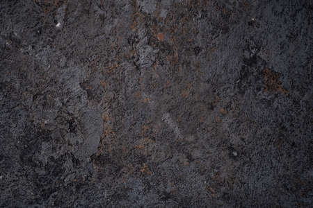 The black texture of the concrete wall is a rough shape. The old stone floor grunge
