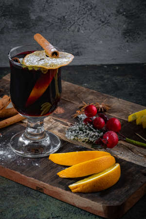 Christmas red wine mulled wine in glasses with spices and cinnamon on a wooden Board. Winter hot drinkの写真素材