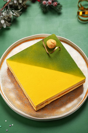 Mousse cake with lemon, mango and chocolate on a decorated festive table, top viewの写真素材