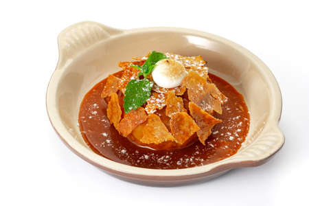 Apple Pie or Tart with caramel, mint crunchy waffles in a bowl on a white backgroundの写真素材