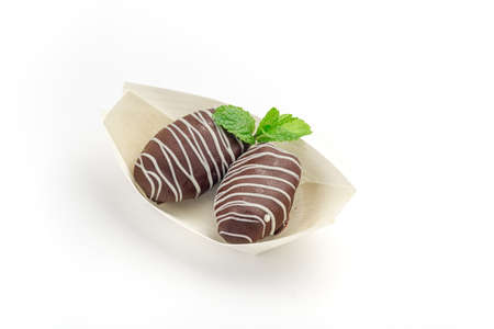 Chocolate covered dates sweet arab candies for dessert isolated on whiteの写真素材