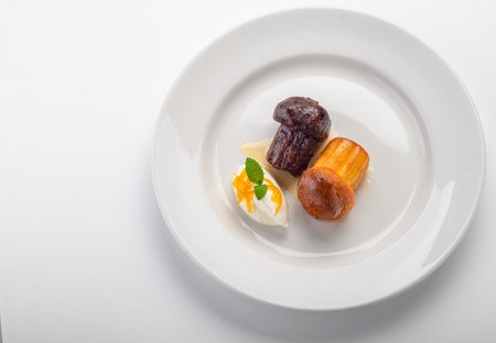 Italian dessert baba from Naples on plate isolated on whiteの写真素材