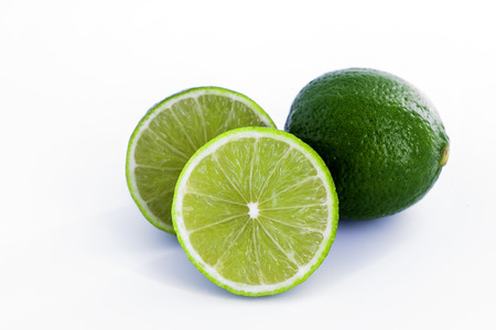 Limes with slices isolated on white background