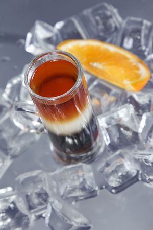 Alcohol ñocktail The Pride of Jamaica on ice cube background