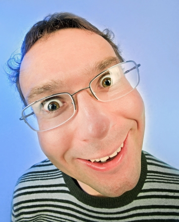 Funny surprised man in glasses portrait on vivid color backgroundの写真素材