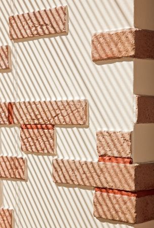 Brickwork Wall striped by sunlightの写真素材