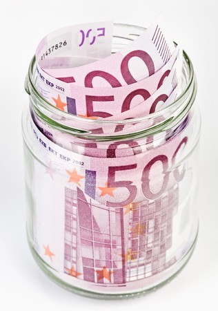 500 Euro bank notes in a glass jar isolated  on white backgroundの写真素材