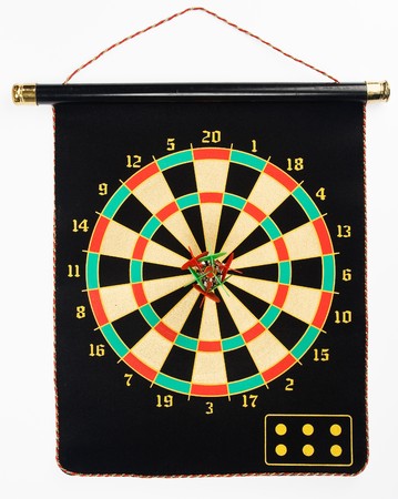 Dartboard with darts hung on a black sheet isolated on whiteの写真素材