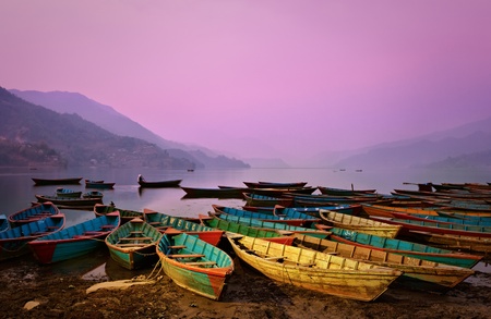 Beautiful twilight landscape with boats on Phewa lake, Pokhara, Nepalの写真素材