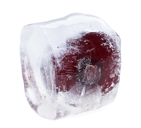 Red sweet cherry inside of melting ice cube, isolated on whiteの写真素材