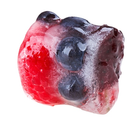 Bilberries raspberry and mulberry fruits inside of melting ice cube, isolated on whiteの写真素材