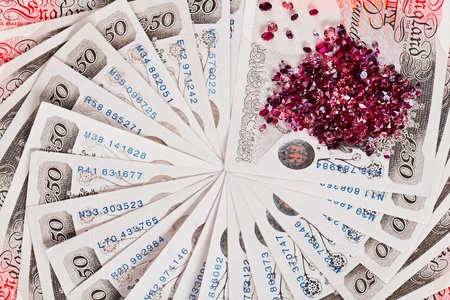 50 pound sterling bank notes with diamonds closeup view business background