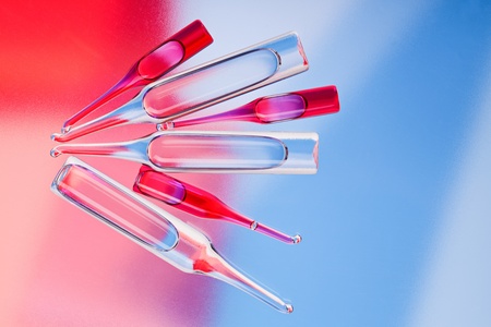 Medical ampoules on red and blue vivid color background