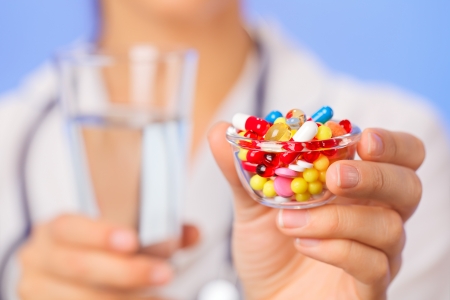 Pills, tablets and drugs heap in doctor hand, closeup view Pills, tablets and drugs heap in doctor hand, closeup view