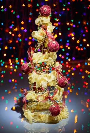 Christmas tree decorated on black multicolored sparkling backgroundの写真素材