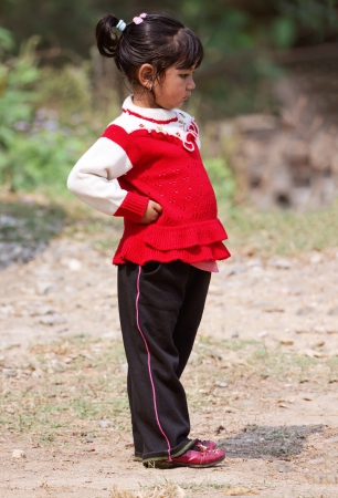 KALANKI - APRIL 2: Portrait of Nepalese girl in red dress April 2, 2009 in Kalanki Village, Kathmandu, Central Region, Nepal. In the first quarter of 2009-10, according to the Nepal Rastra Bank, the country exports had declined (17 percent) and imports coのeditorial素材