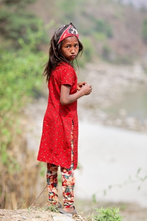 KALANKI - APRIL 2: Portrait of Nepalese girl in red dress April 2, 2009 in Kalanki Village, Kathmandu, Central Region, Nepal. In the first quarter of 2009-10, according to the Nepal Rastra Bank, the country exports had declined (17 percent) and imports coのeditorial素材