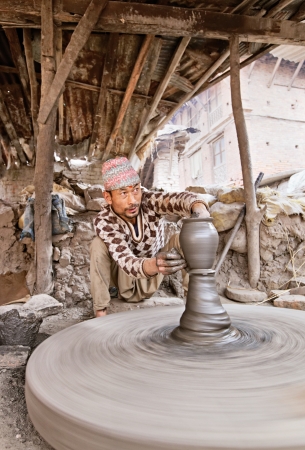 BHAKTAPUR, NEPAL - APRIL 5  Bhaktapur indigenous potter makes earthenware with turning wheel on April 5, 2009 in Bhaktapur, Nepal  Bhaktapur is listed as a World Heritage Site by UNESCO for its rich culture, temples, and wood, metal and stone artwork のeditorial素材