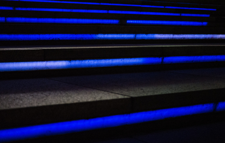 A photo cool futuristic looking staircase with blue lighting, taken at nightの写真素材