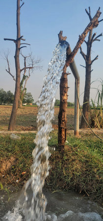 Powerful stream of clean groundwater flowing from a tube well, a strong jet of clear water