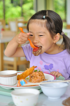 Girl eat dinner menu for childrenの写真素材