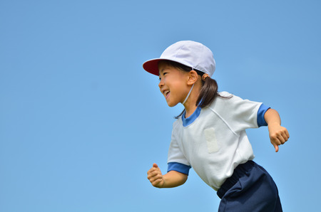 Girl in blue sky gym clothes, red white hat