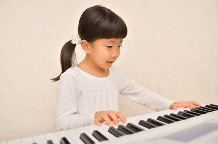 Girls playing the pianoの写真素材