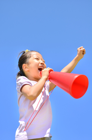 Cheer megaphone girl blue skyの写真素材