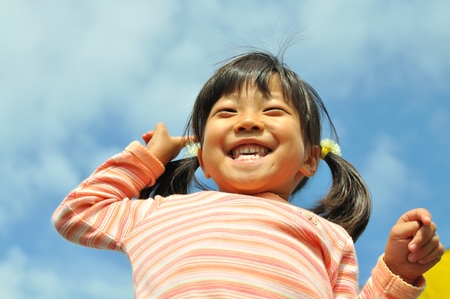 Girl to laugh at the blue skyの写真素材