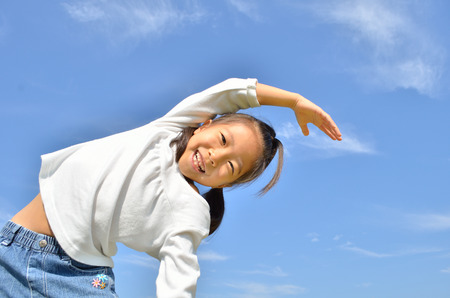Girls gymnastics in the blue skyの写真素材