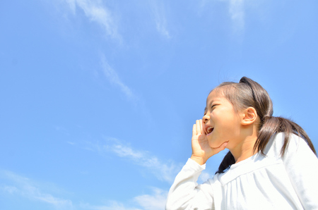 Girl in blue skyの写真素材