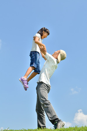 Parent-child a hug in the blue skyの写真素材