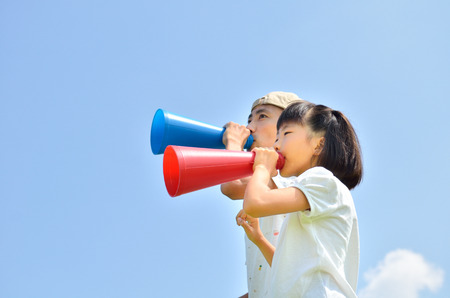 The parent and child to cheer on the blue sky summer, megaphoneの写真素材