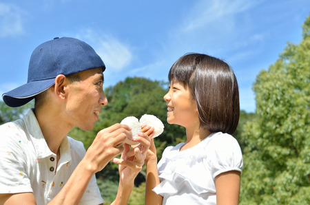 Parent and child eat rice ballの写真素材