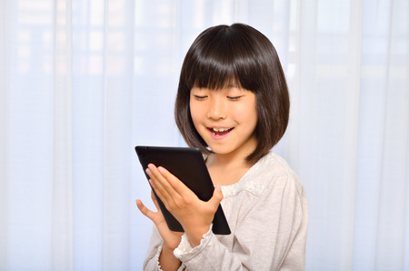 Girls enjoying with Tablet PCsの写真素材