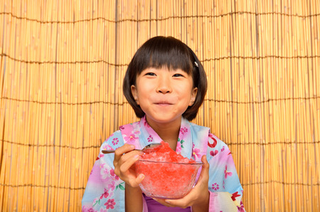 Girl eating poker ice (Kimono)の写真素材