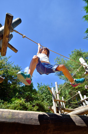 A girl playing at the playground in the Parkの写真素材