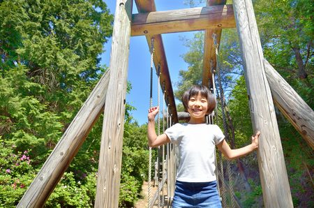 A girl playing at the playground in the Parkの写真素材