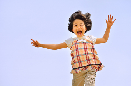 Girl running (blue sky)の写真素材