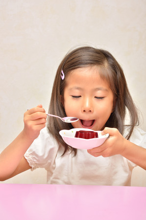Girl eating delicious jellyの写真素材