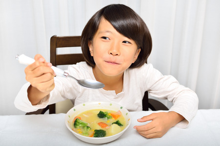 Girl eating delicious stewの写真素材