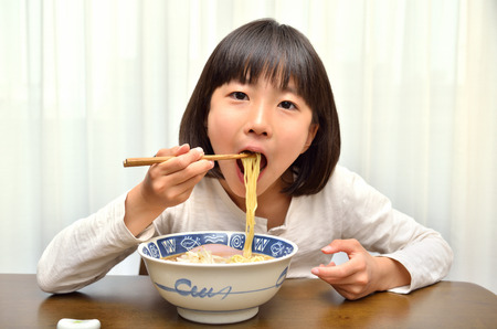 Girls eat delicious noodlesの写真素材
