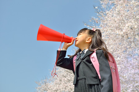 Girls cheer (megaphone, cherry, blue sky)の写真素材