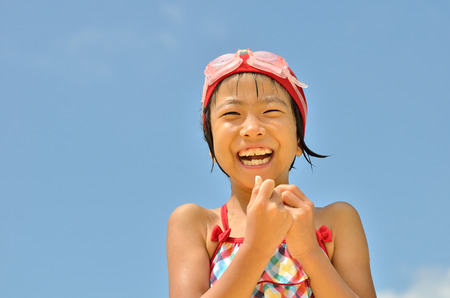 Girls laughing in the sky (swimsuit)の写真素材