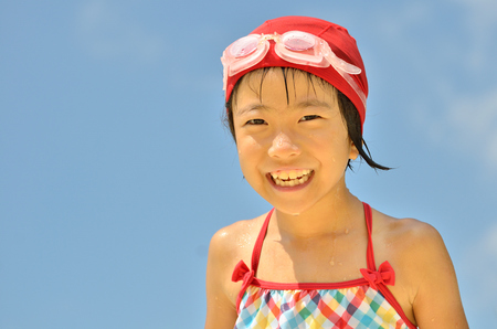 Girls laughing in the sky (swimsuit)の写真素材