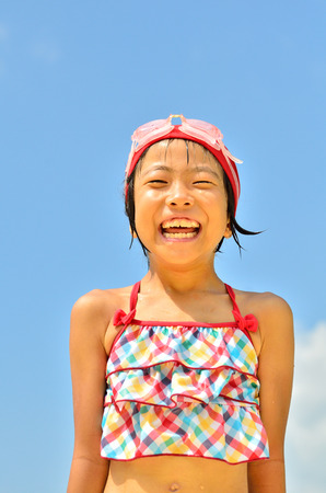 Girls laughing in the sky (swimsuit)の写真素材